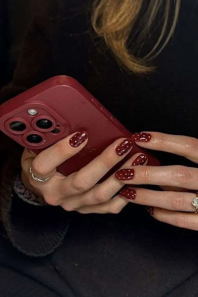 Polka dot nails in deep red, short length
