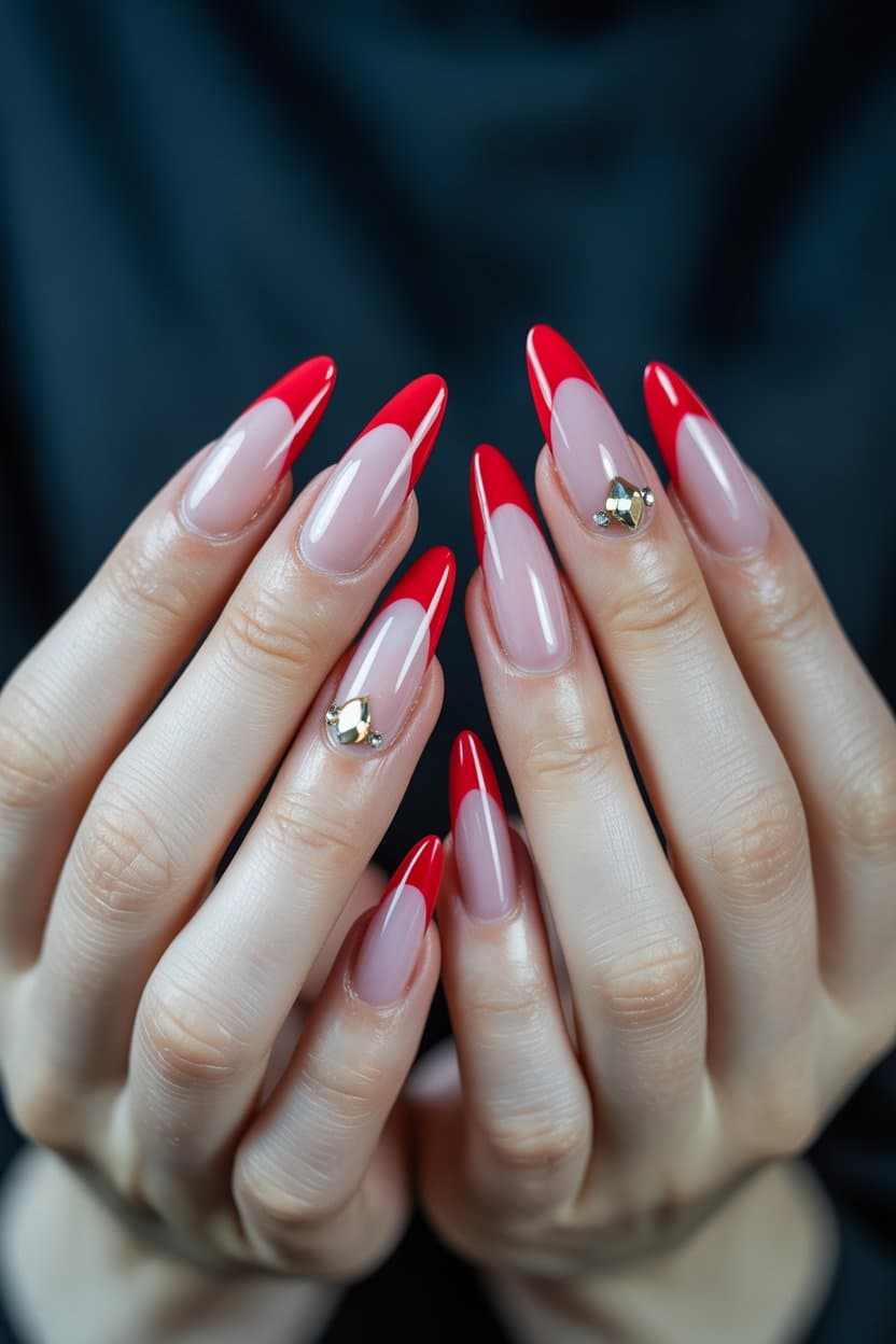 Bold red French nails with rhinestones, stiletto shape