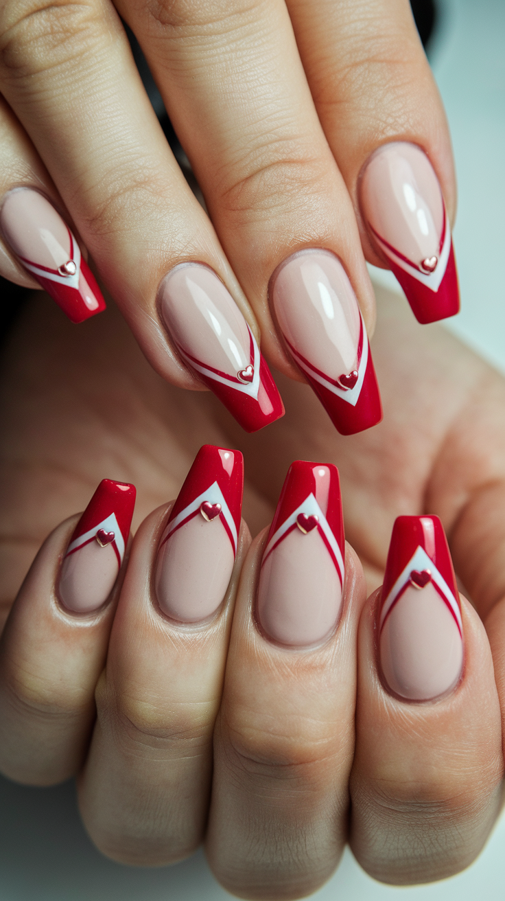 V-shaped red French nails with heart accents, medium length
