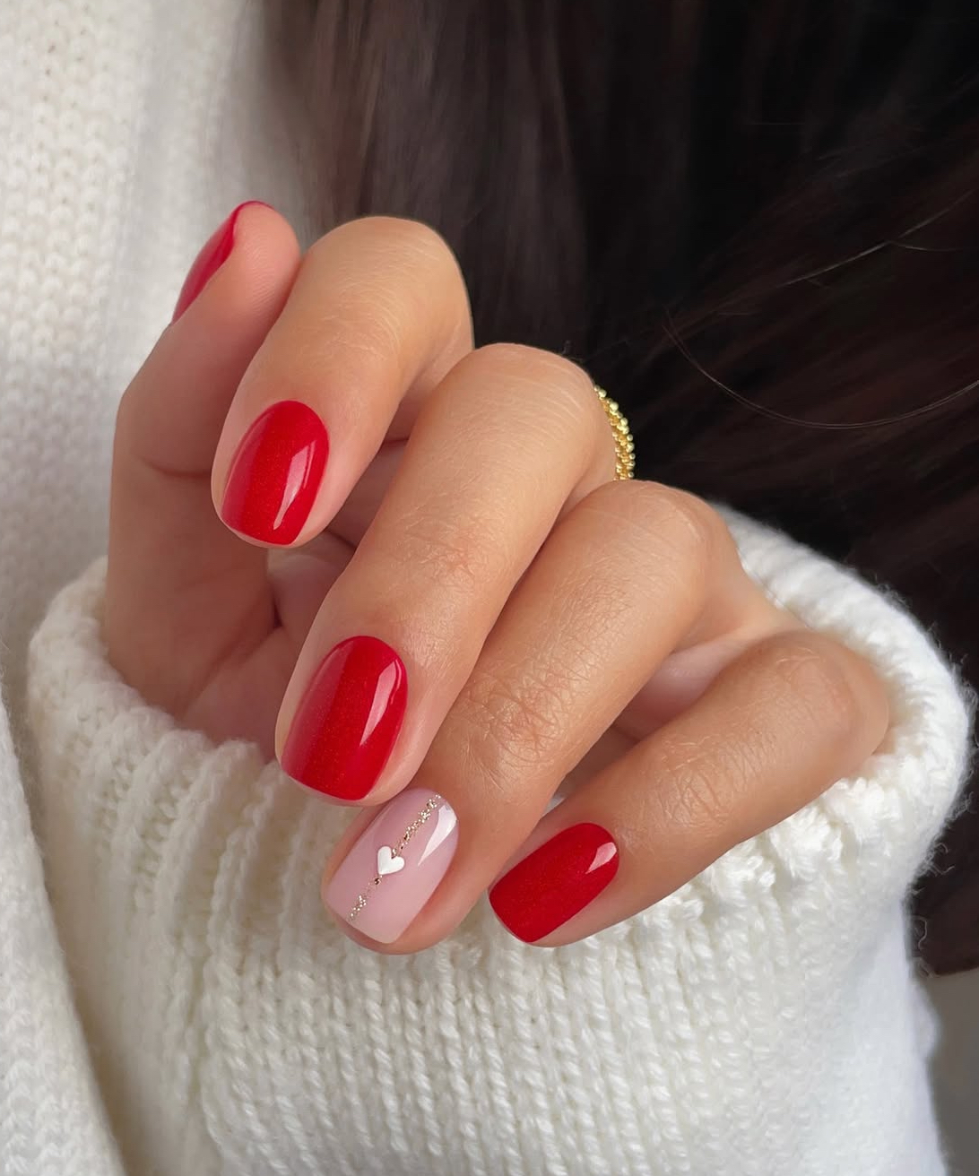 Glossy red nails with heart accent, short length