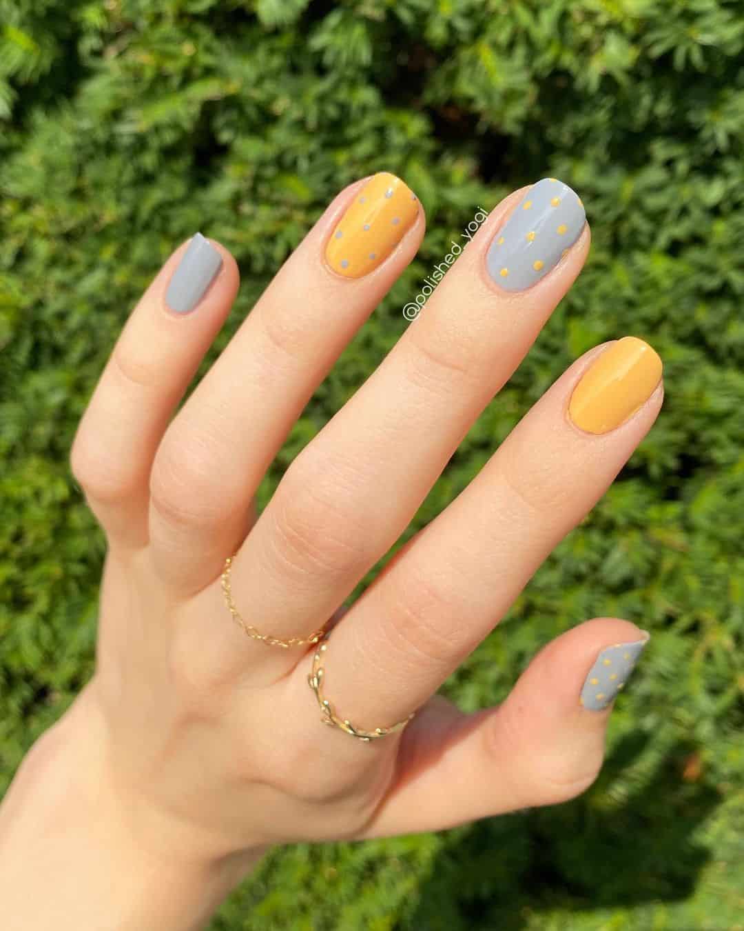 Polka dot design on short round nails, playful colors