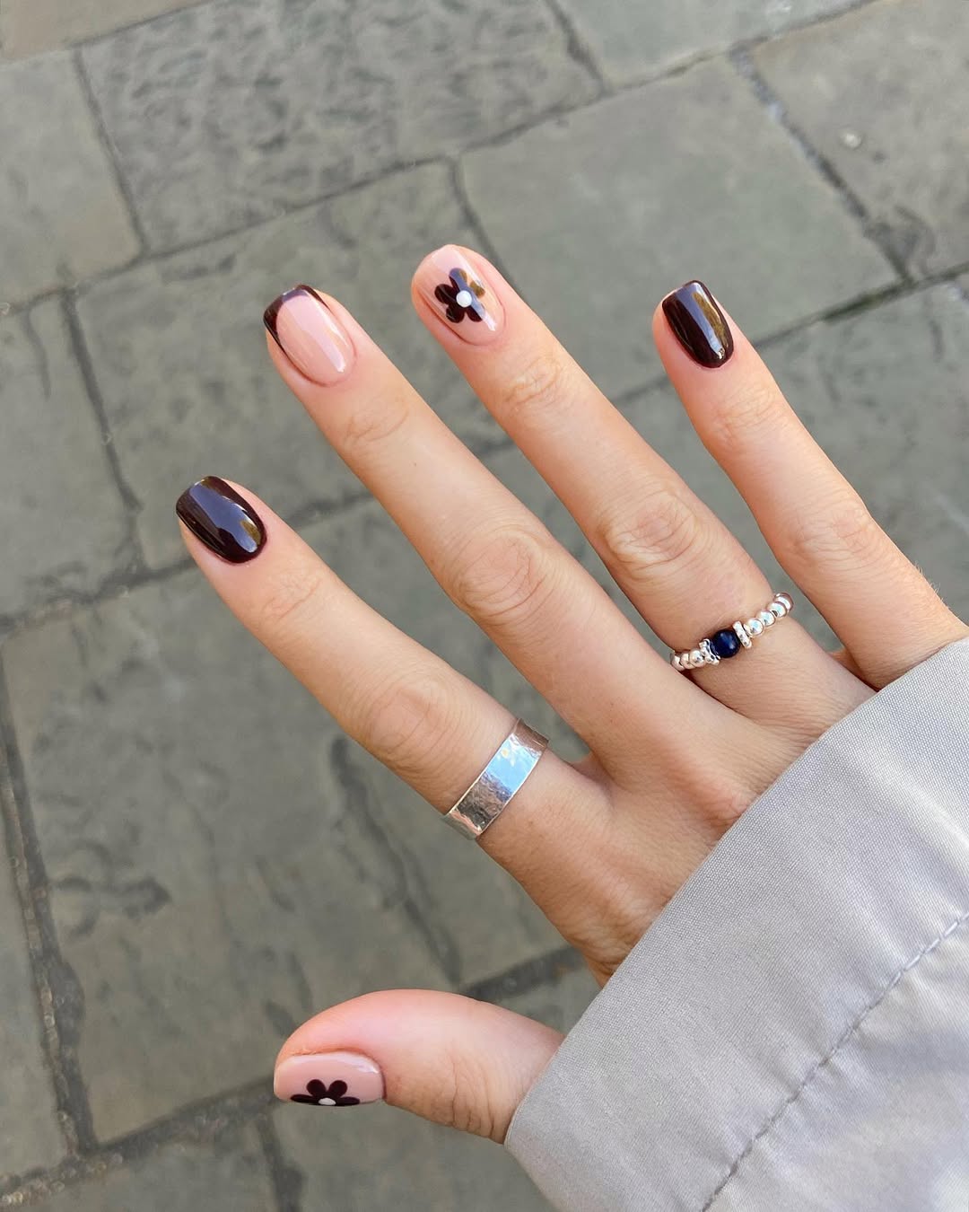 Floral accents with chocolate hues, square nails