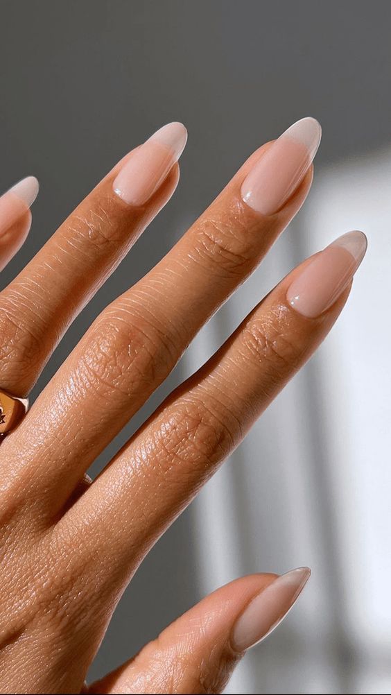Short almond nails with sheer nude polish