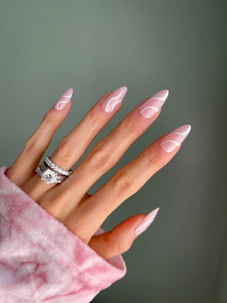 Pink and white swirl nails, elegant wave design.