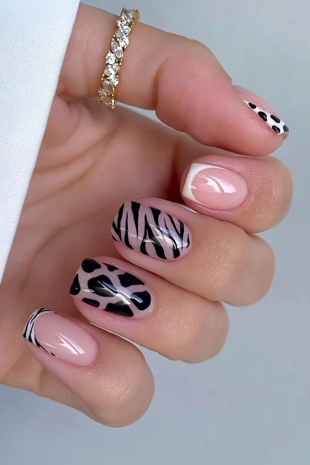 Animal print accent nails, bold and chic, trendy design.