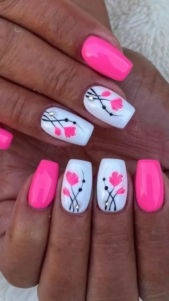 Bright pink and white floral nails, playful and fun design.