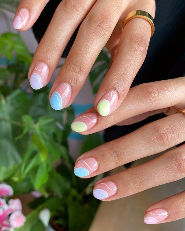 Pastel nails with colorful swirls, soft and playful.