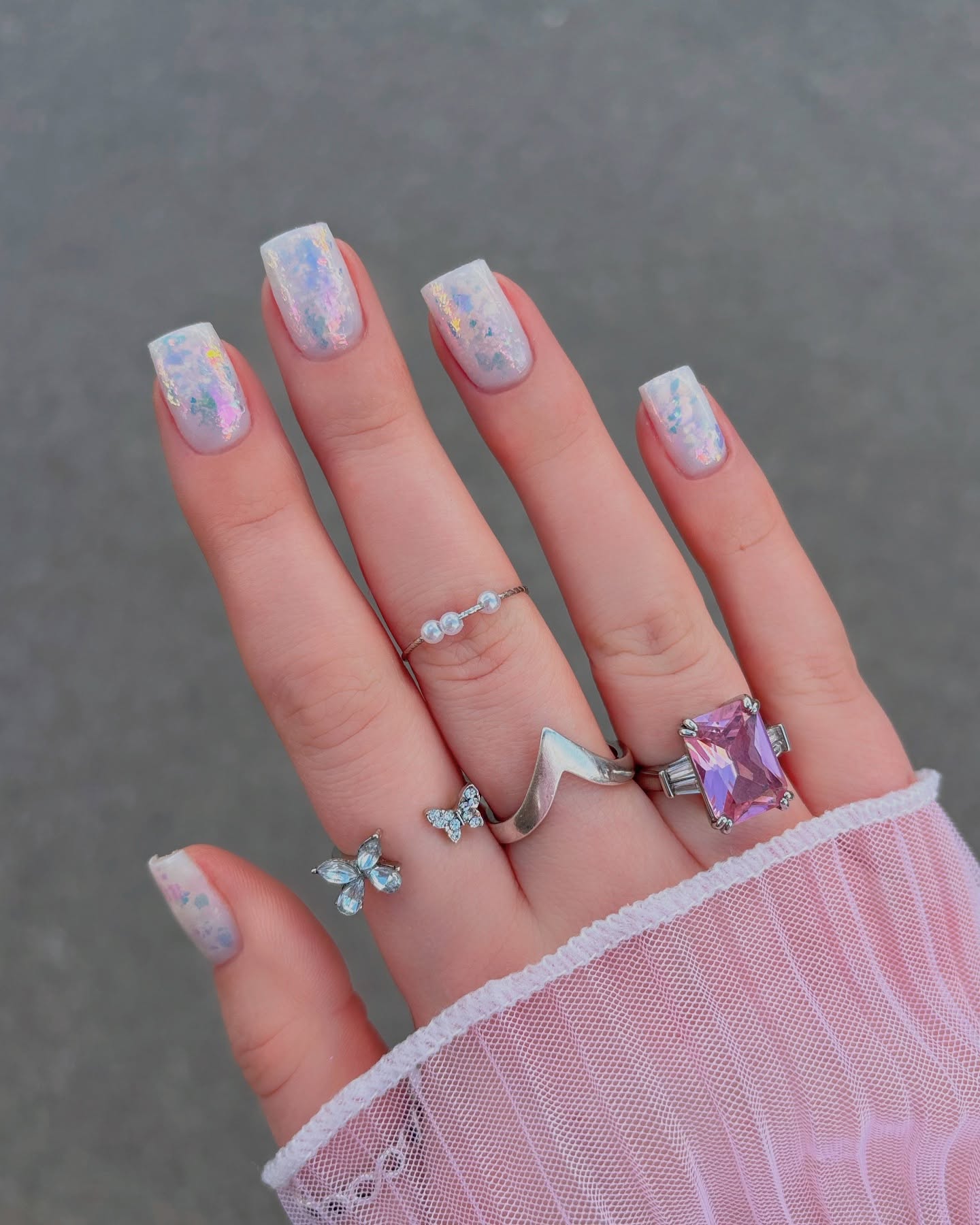 Holographic nails with iridescent finish, chic and modern.