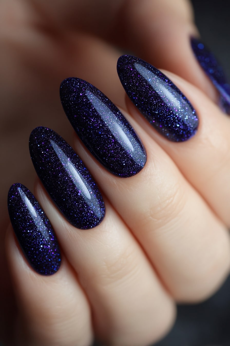 Dark blue glitter nails, galaxy-inspired nail design