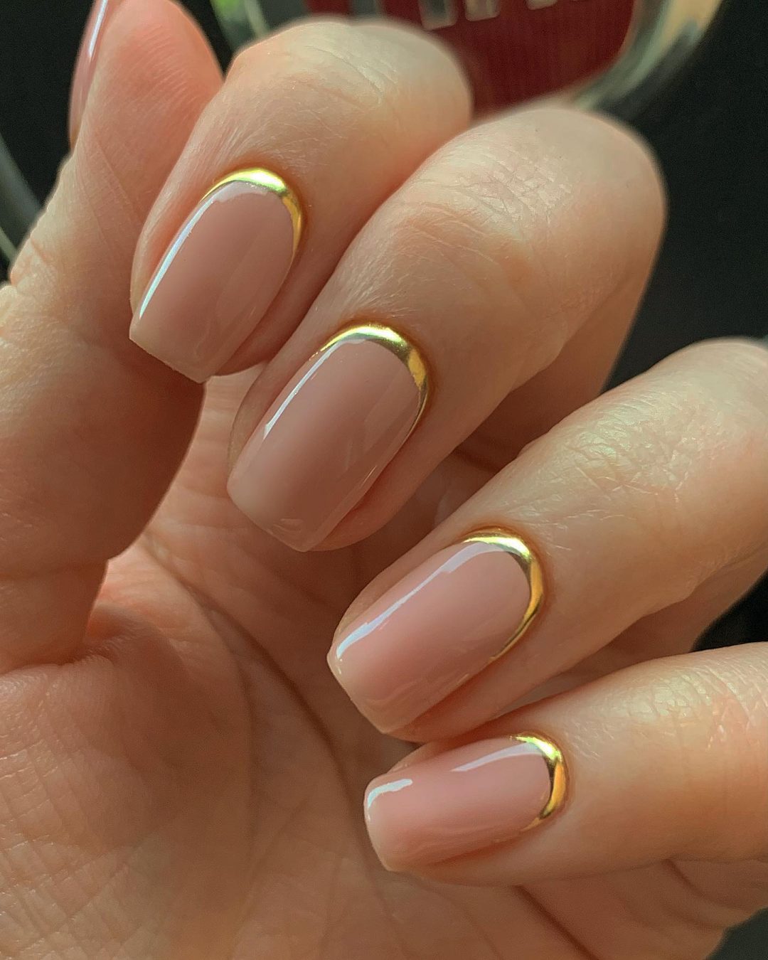 Gold cuticle accents on nude nails, luxurious and modern