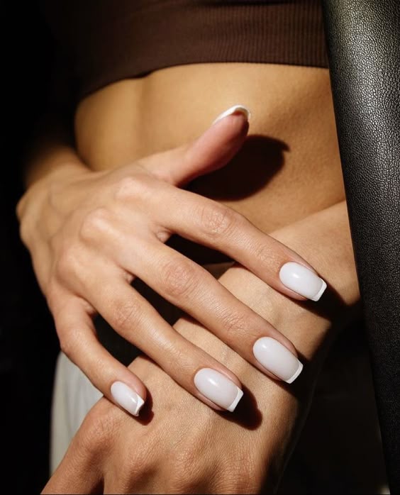 Classic white French manicure on short nails, timeless elegance