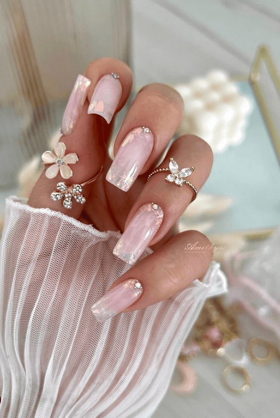 Pink floral nails with embellishments, delicate and romantic
