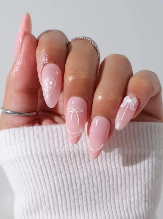 Delicate pink nails with white accents, feminine and graceful