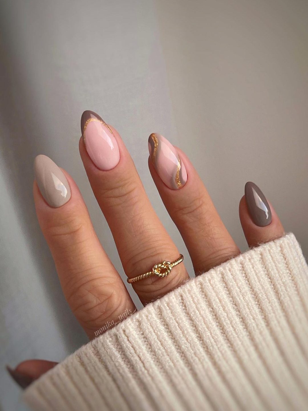Neutral tone nails with artistic swirls, elegant and refined
