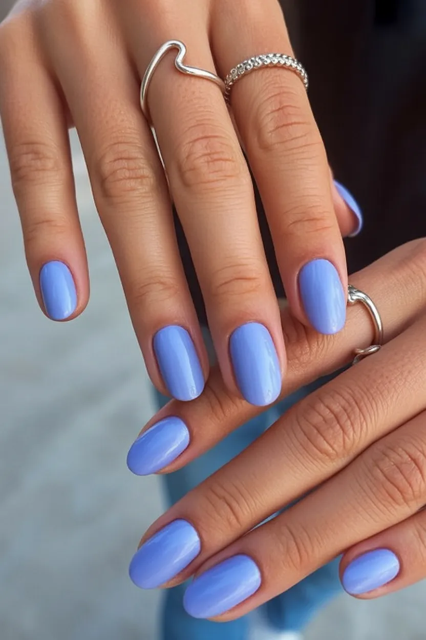 Periwinkle nails with a glossy finish and short shape