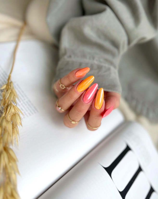Vibrant sunset nails with long almond shape and glossy finish