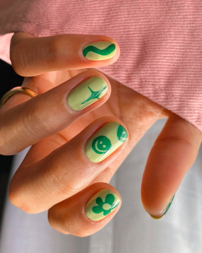 Playful green nails with short round shape and quirky design