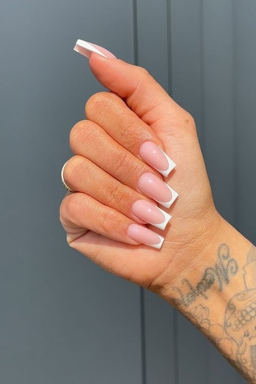 Classic white French tips on long square nails.