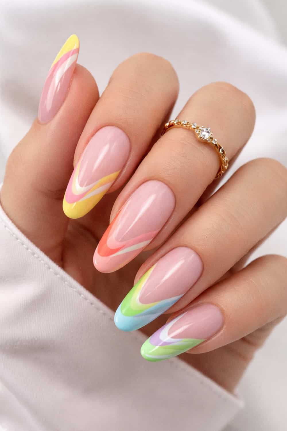 Pastel rainbow French tips on long oval nails.