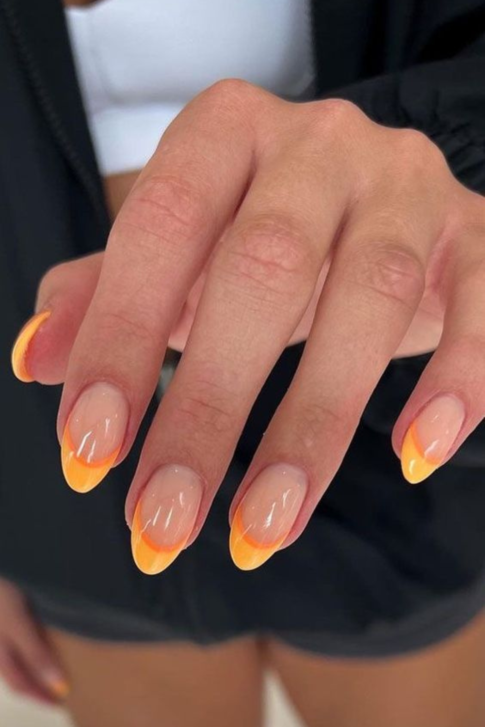 Orange French tips on almond nails