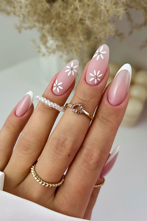 Daisy-adorned French tips on long oval nails