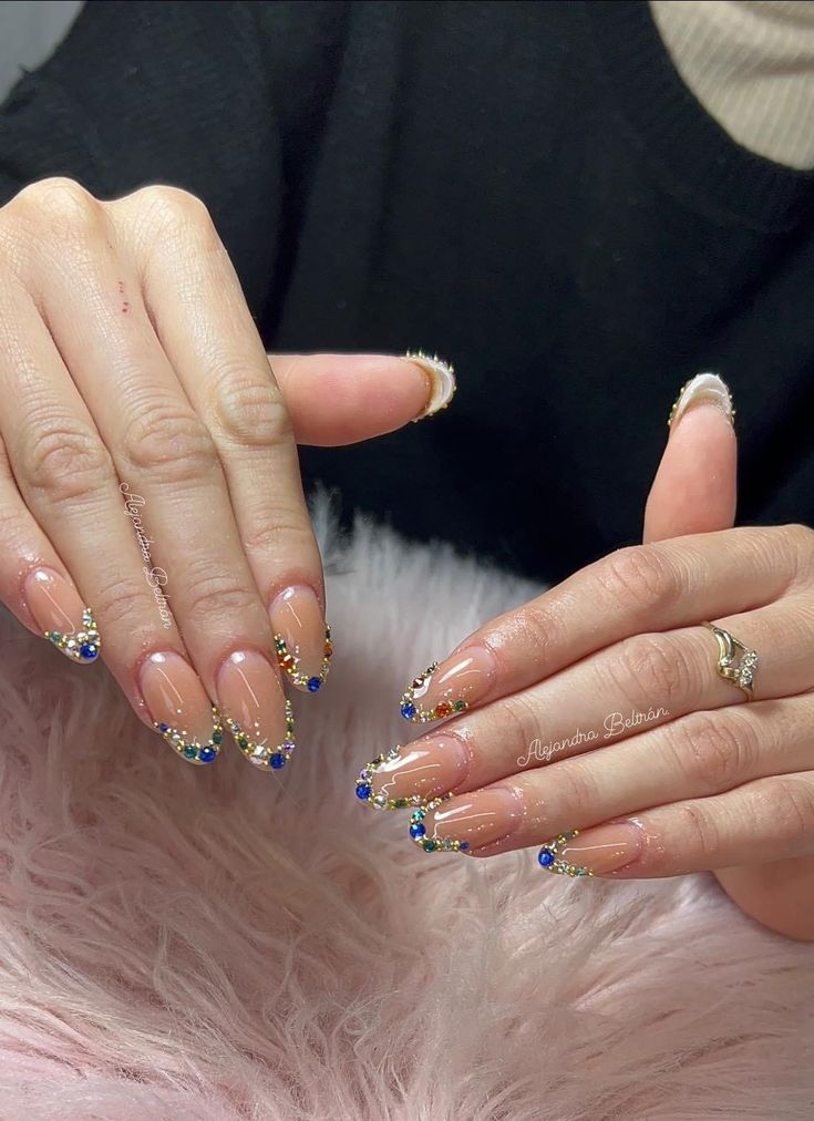 Gem-studded French tips on almond nails