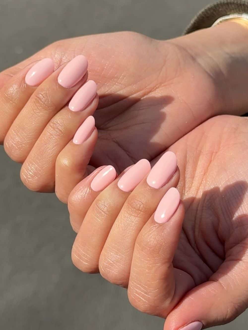 Soft pink manicure on short oval nails.
