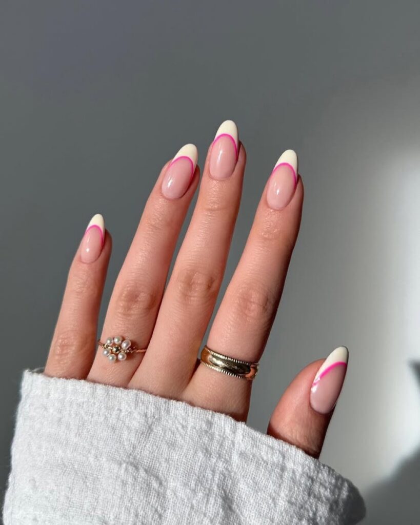 Pink-tipped French manicure on almond nails.