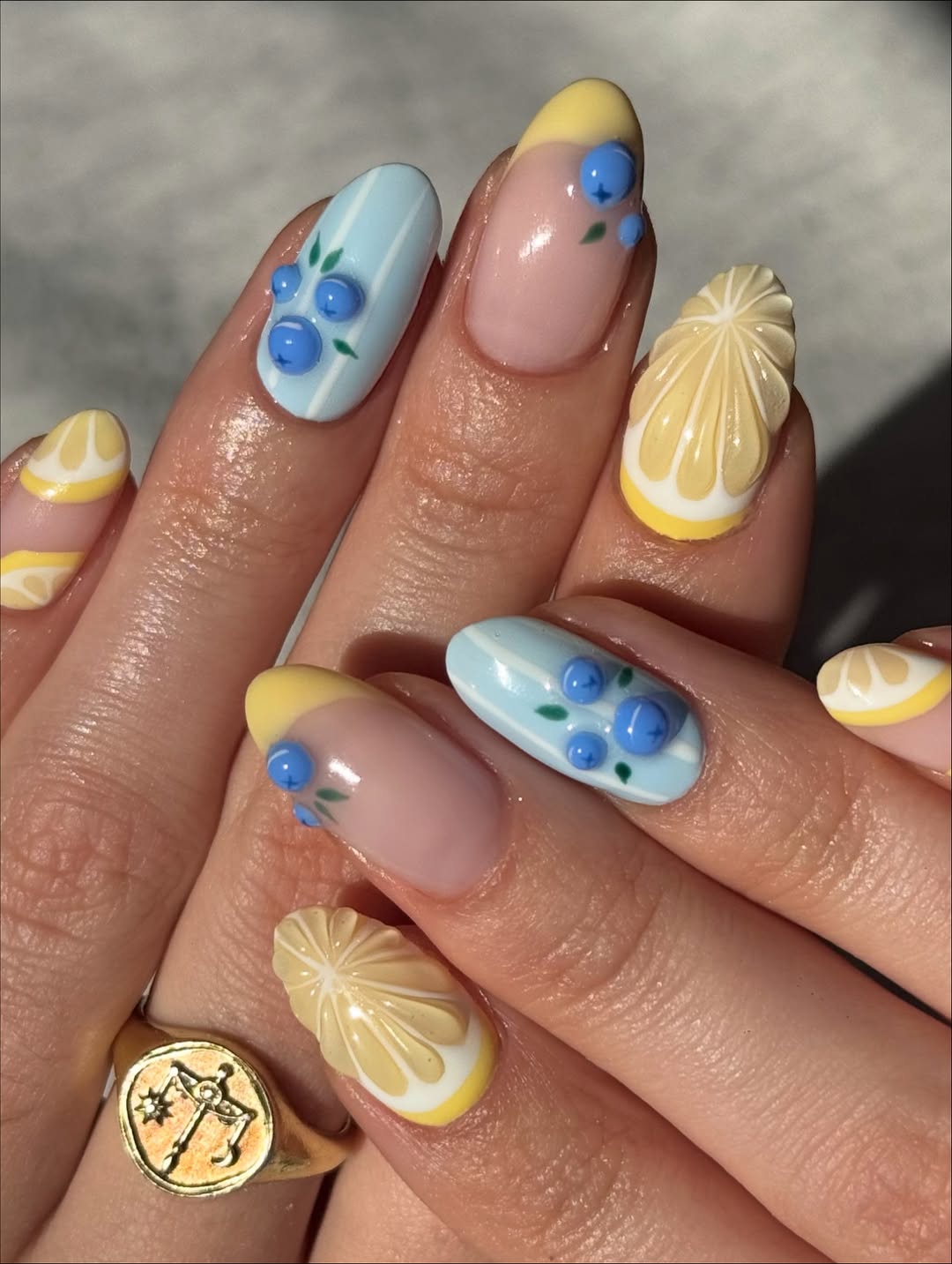 Lemon and flower nail art on almond nails.