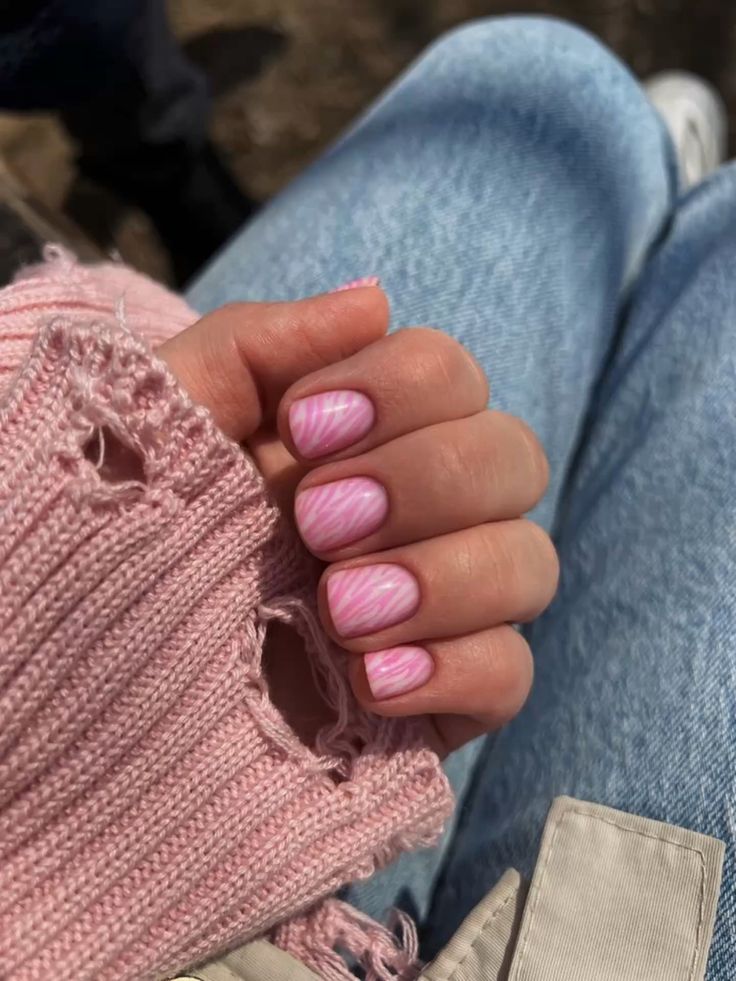 Pink candy stripe nail art on short nails.