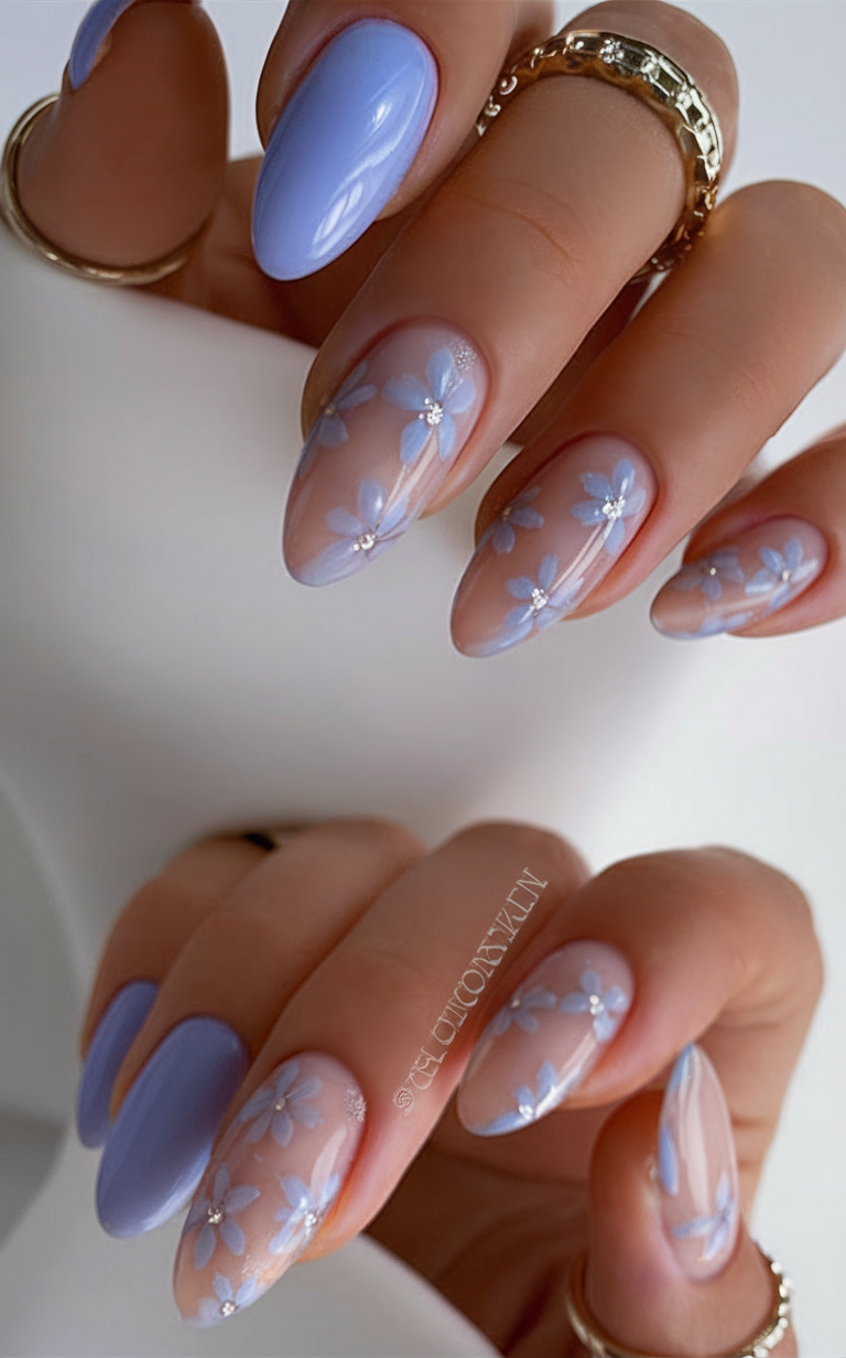 Blue petal nail art on almond nails.