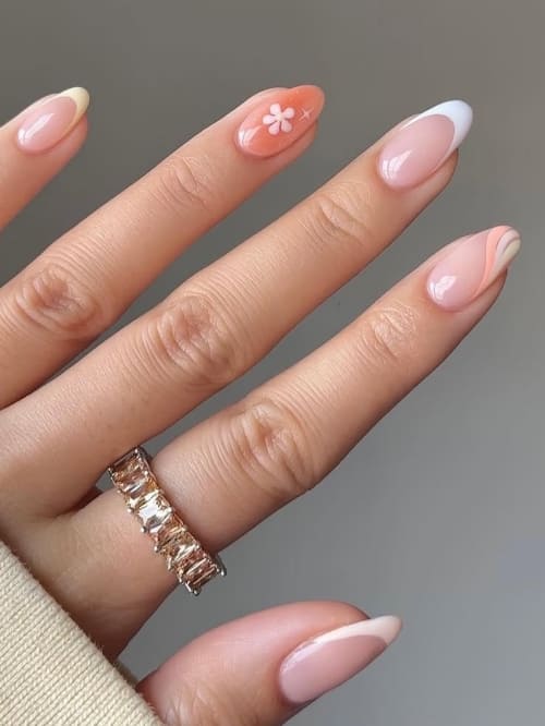 Mixed spring swirl nail art on almond nails.