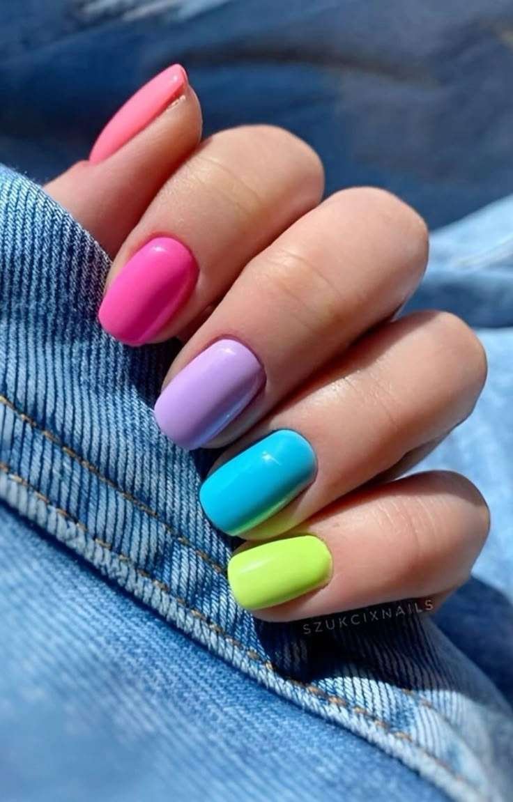 Rainbow-colored nails on short square nails.