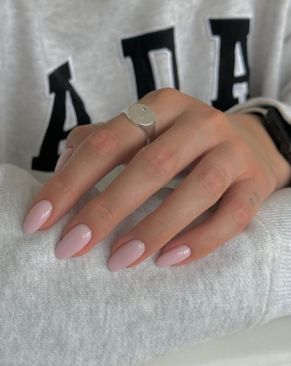 Soft pink glossy nails on almond shape.