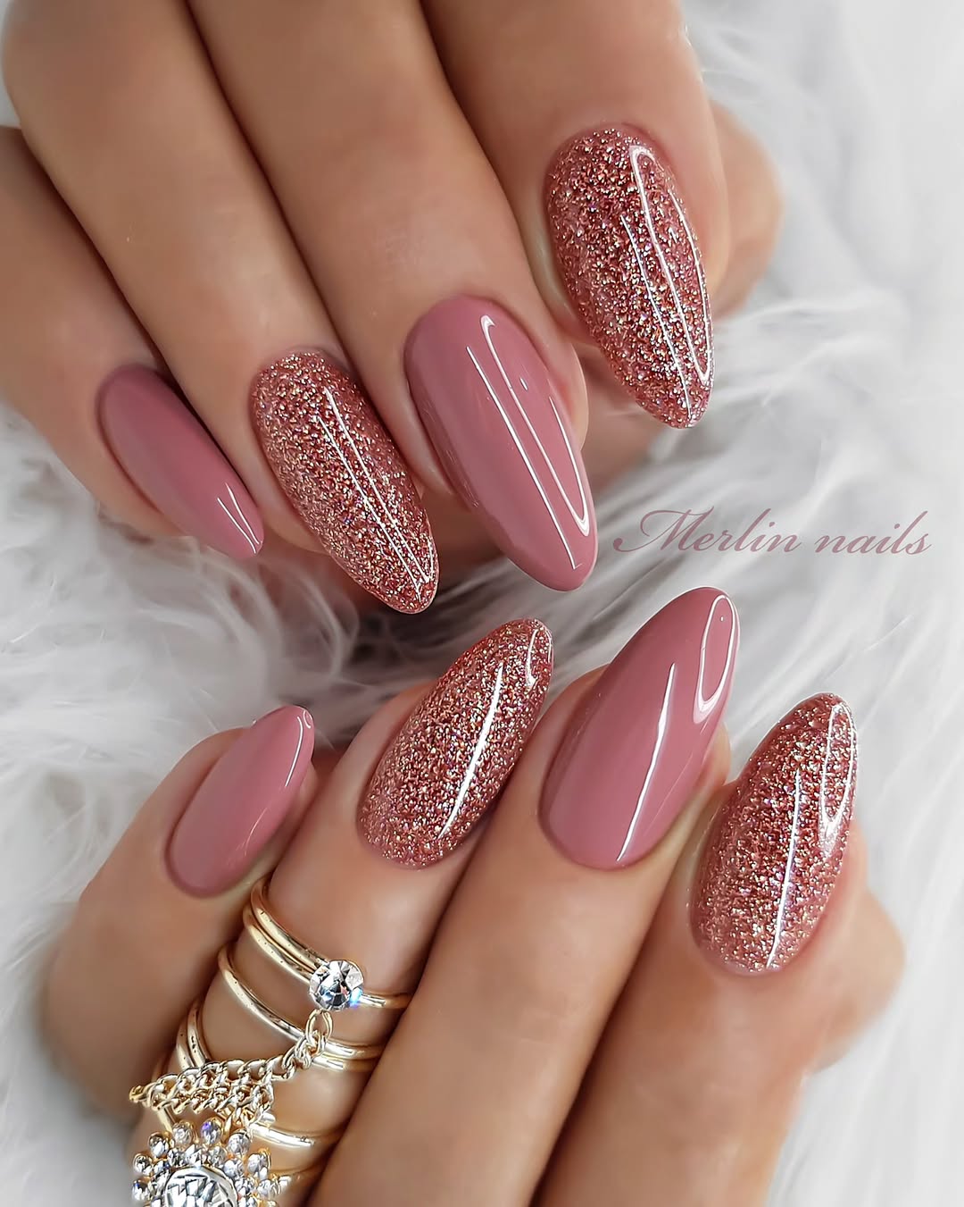Rose gold glitter nails on almond shape.