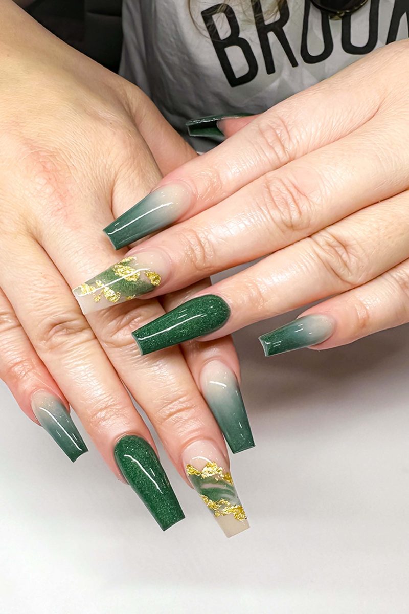 Emerald green marble nails with gold accents on long coffin shape.