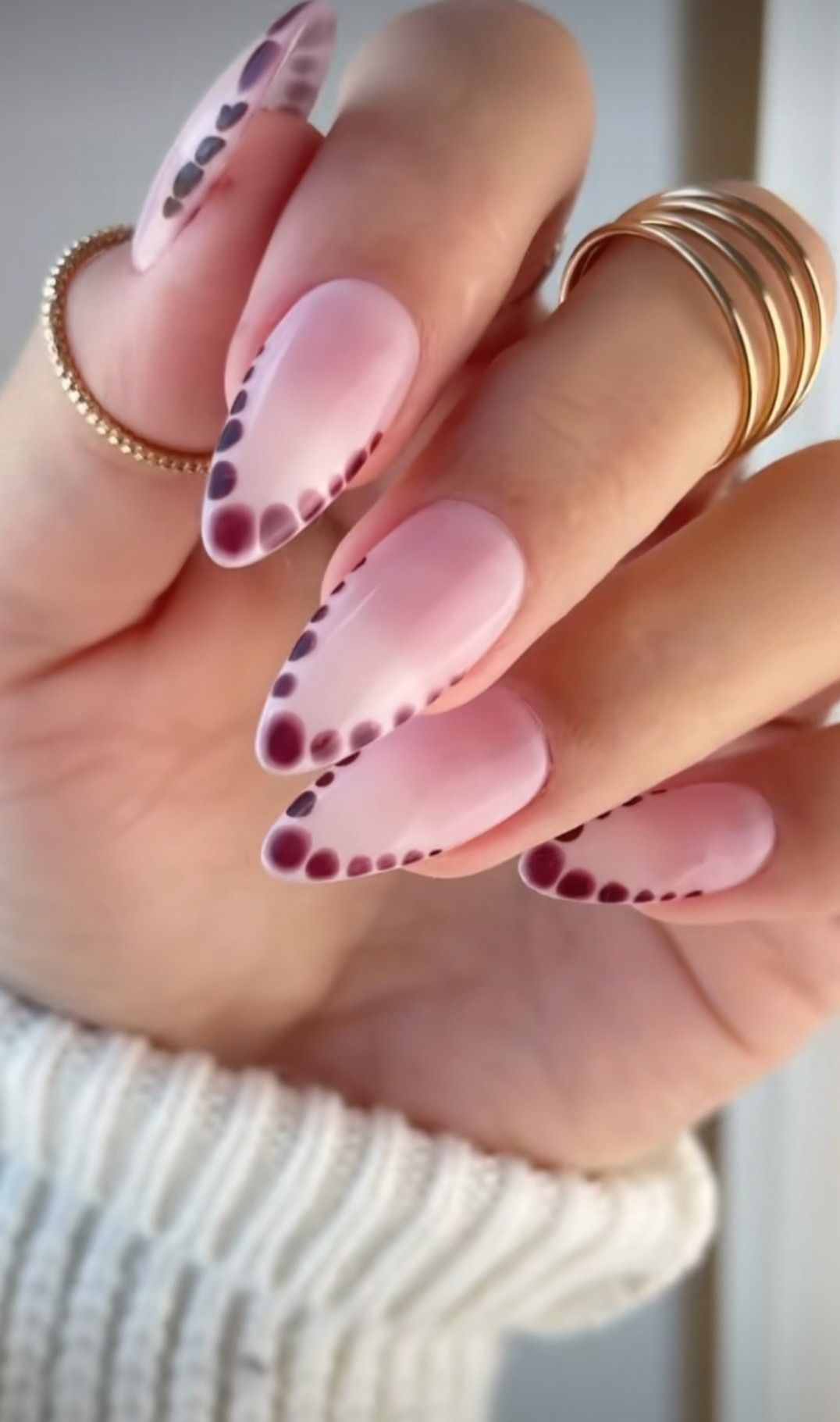 Pink nails with retro dot tips on almond shape.