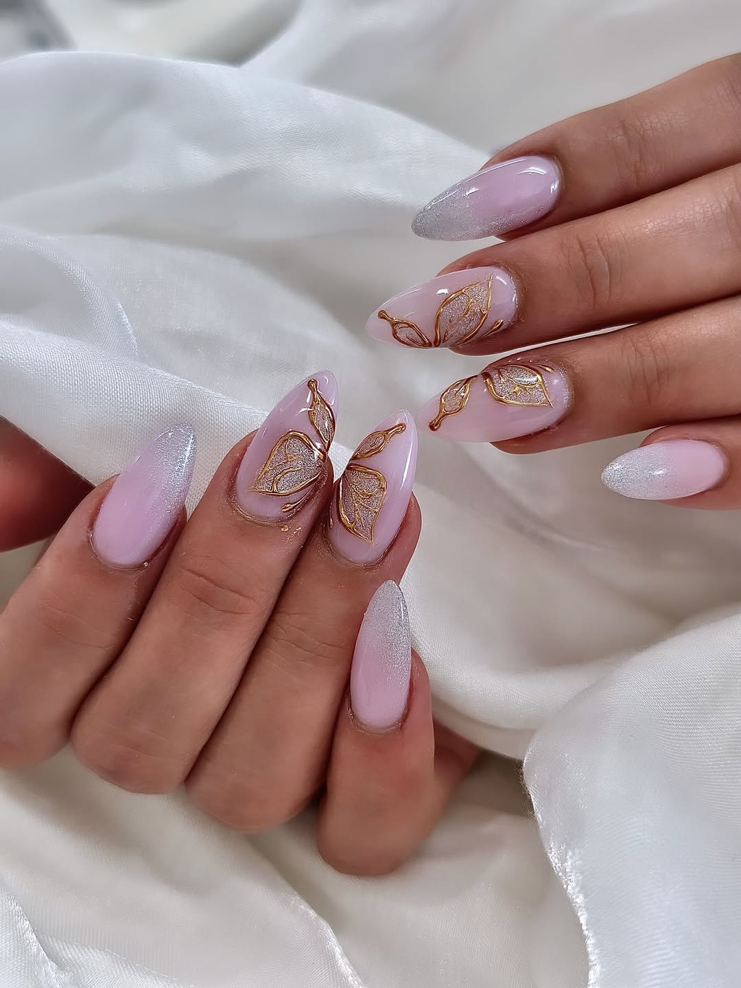 Pink ombre nails with gold butterfly accents, elegant spring nails, intricate design
