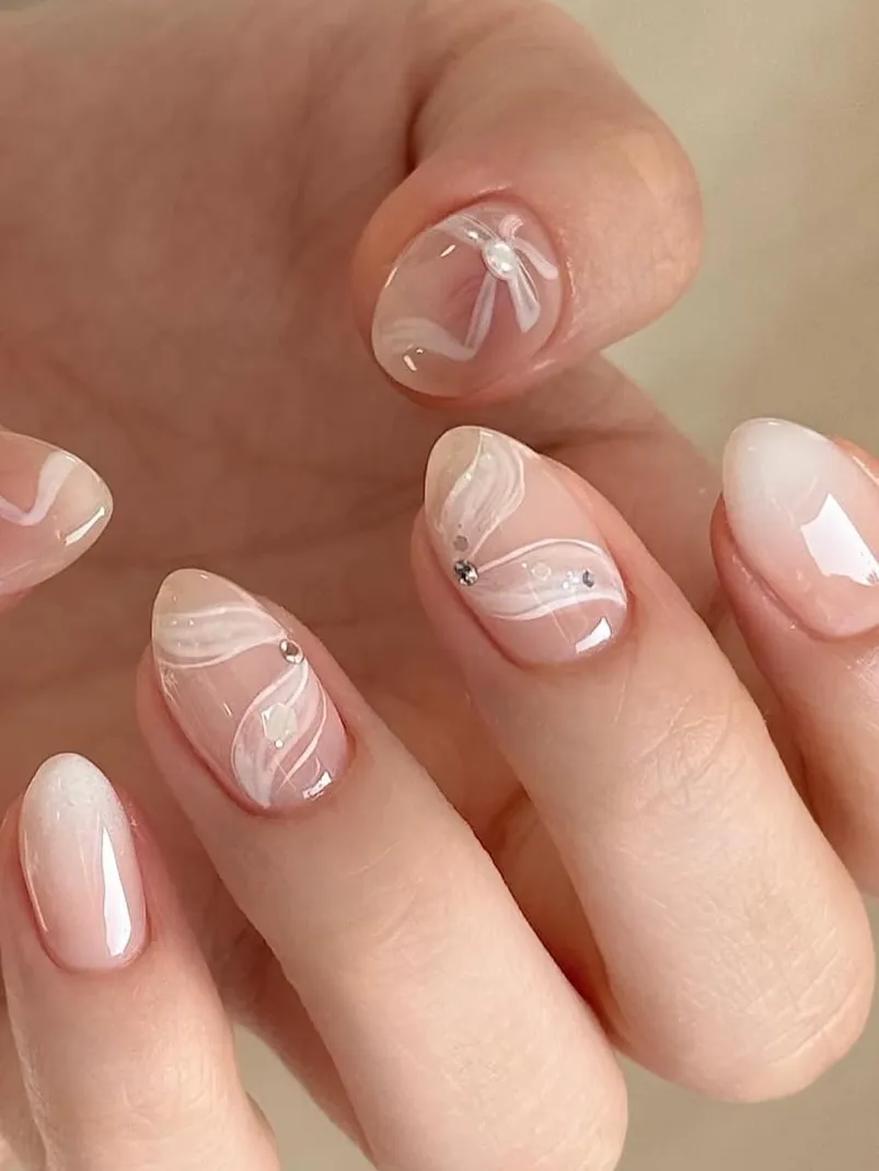 Lace-inspired nails with rhinestones, elegant spring nails, intricate design