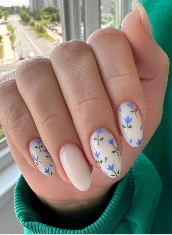Floral nails with blue accents, fresh spring design, elegant nail art