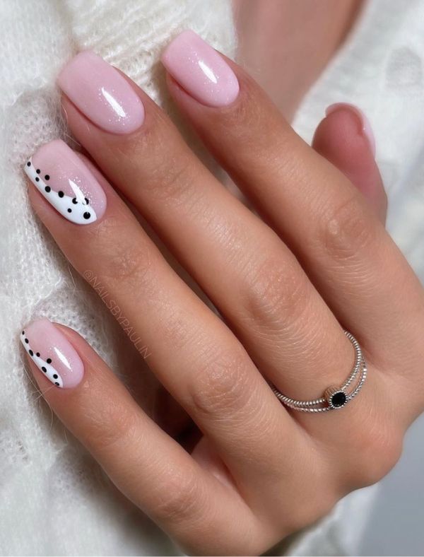 Pink pastel square nails with polka dot accent.