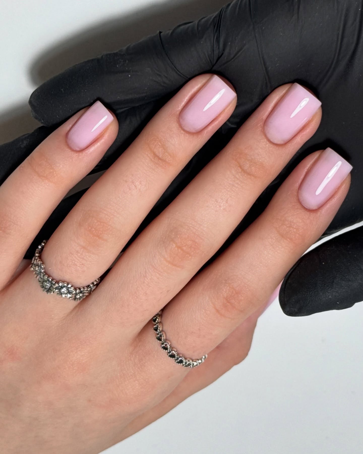 Short square nails with soft pink polish.