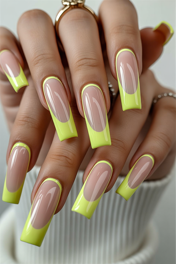 Long square nails with neon yellow French tips.