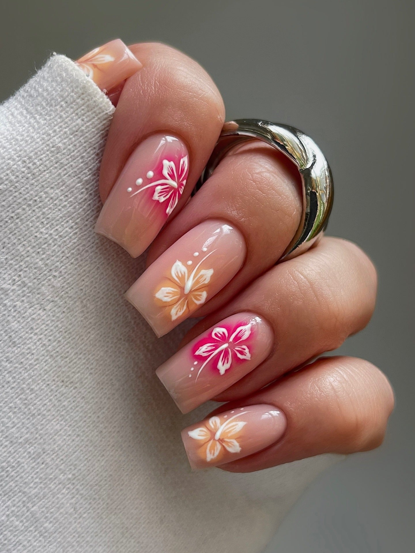Short square nails with floral nail art.
