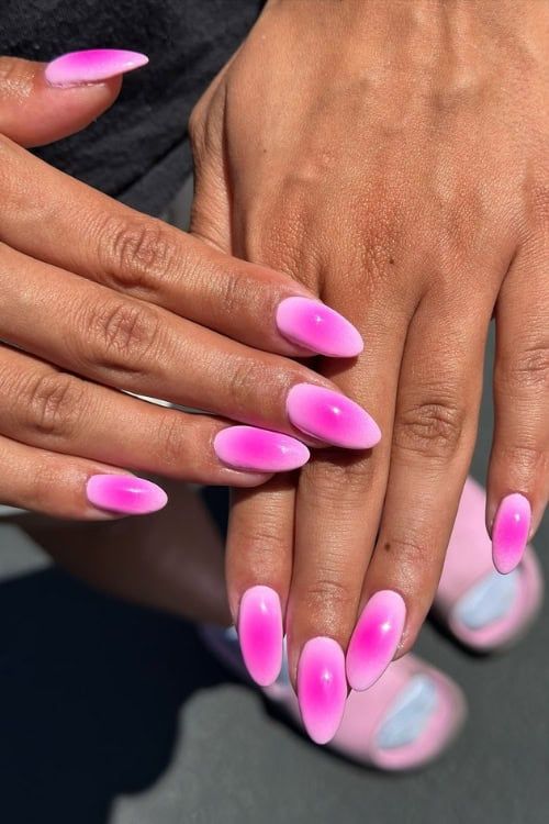 Almond nails with pink ombré effect.