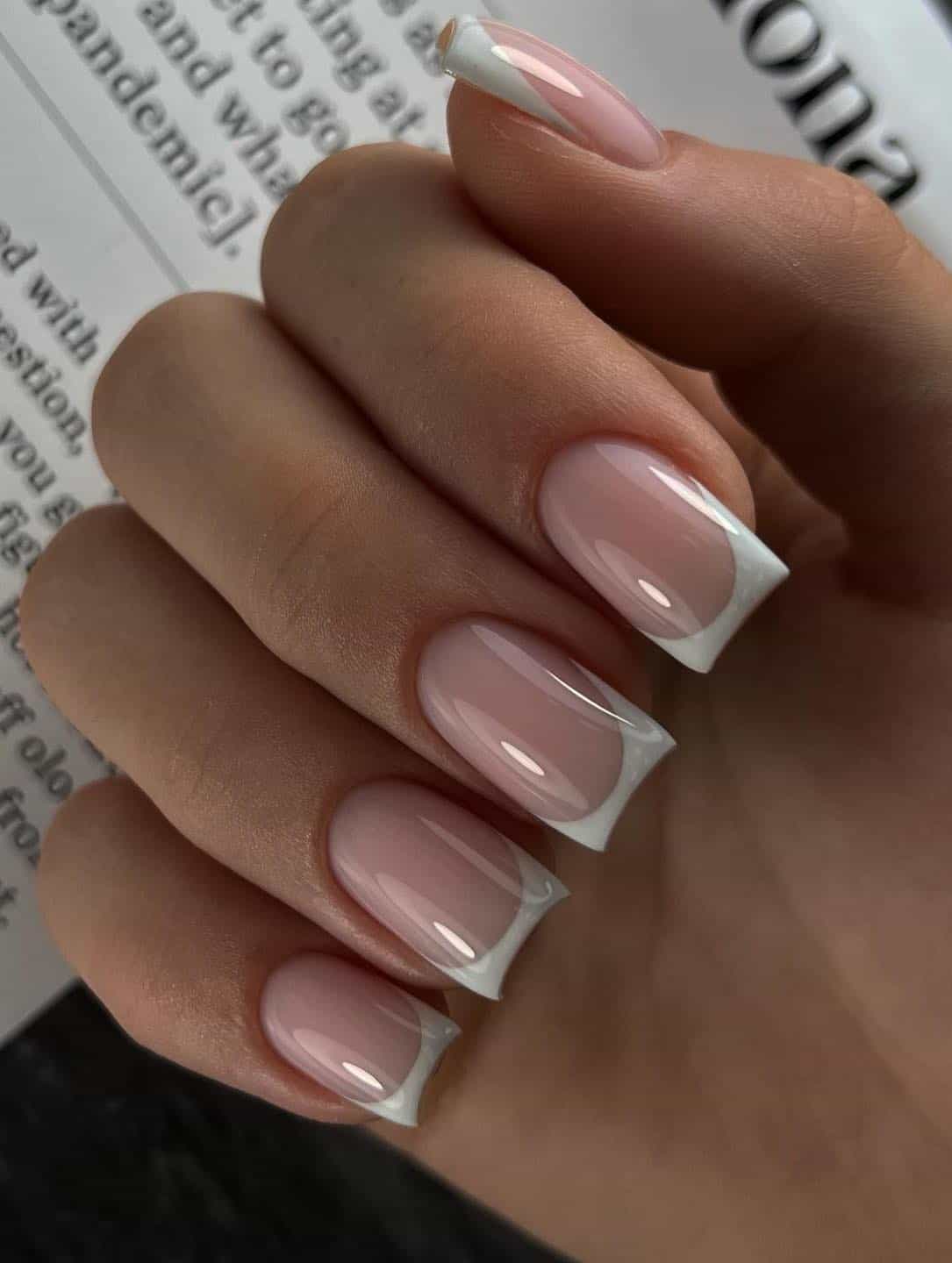 Short square nails with French manicure and glossy finish.