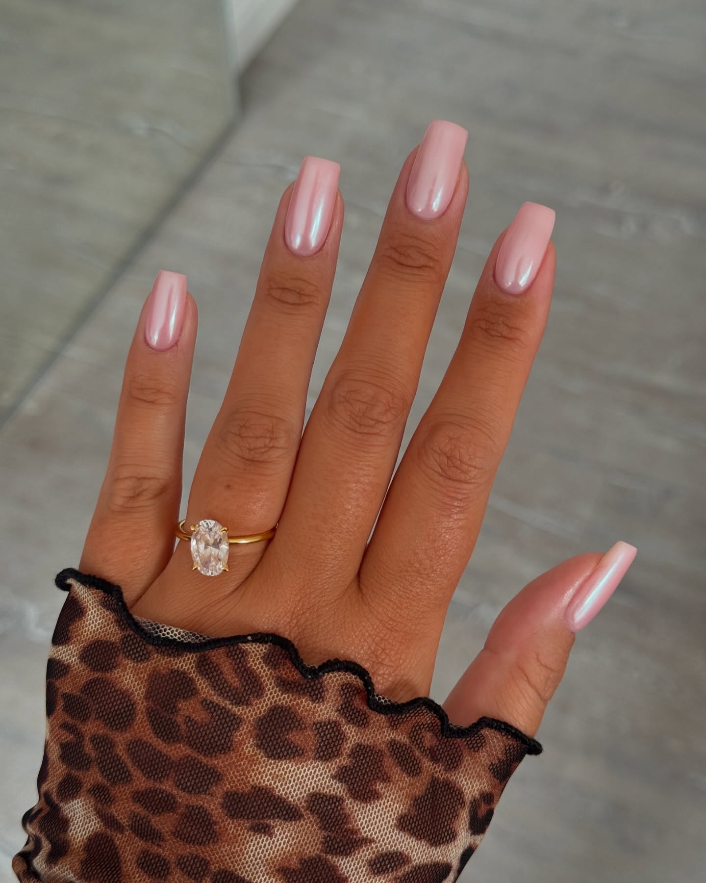 Medium square nails with pearly pink polish.