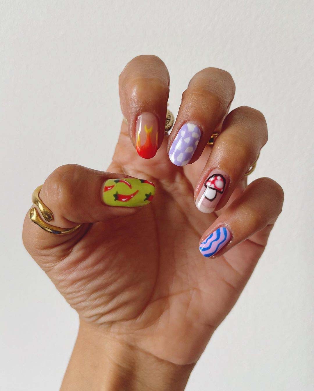 Short nails with eclectic colorful designs.