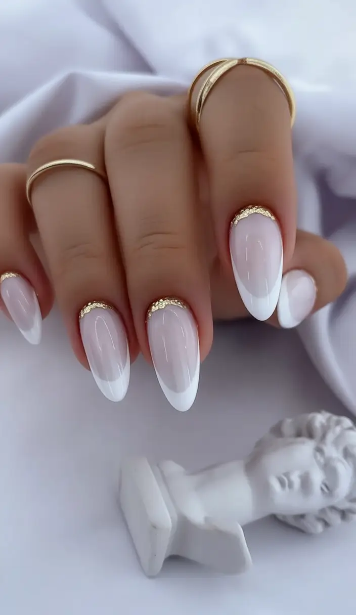 Almond-shaped French manicure with gold accents, luxurious bridal nail art.
