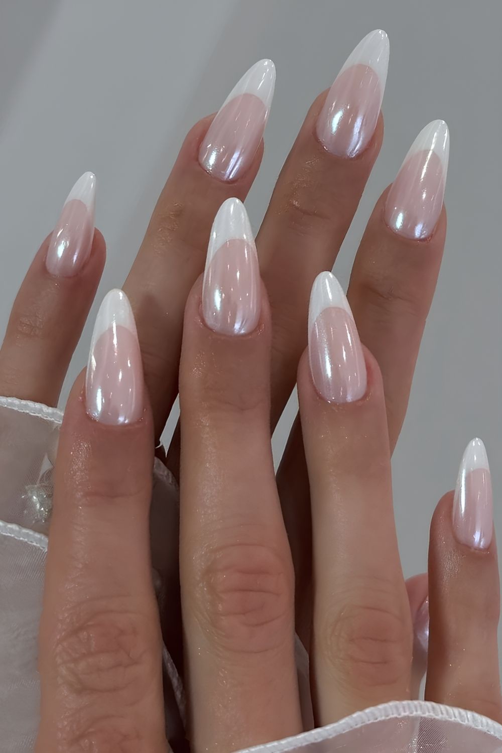 Almond-shaped French ombre nails, modern bridal elegance.